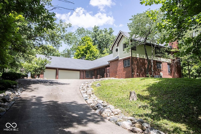 5530 Shawnee Trail S Drive, Indianapolis, IN 46220 - view of front of property featuring brick siding, an attached garage, asphalt driveway, and a front lawn
