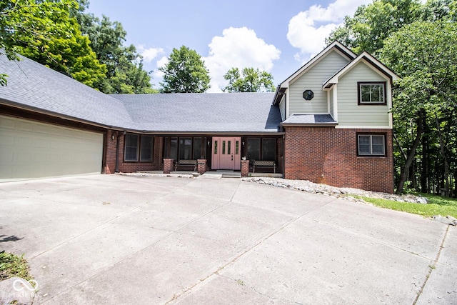 5530 Shawnee Trail S Drive, Indianapolis, IN 46220 - traditional home featuring brick siding, an attached garage, concrete driveway, and a shingled roof