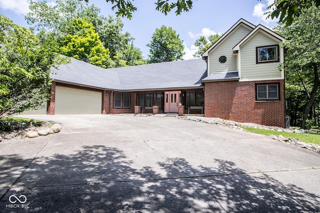 5530 Shawnee Trail S Drive, Indianapolis, IN 46220 - traditional-style house featuring brick siding, concrete driveway, a garage, and roof with shingles