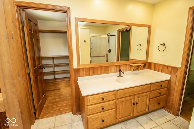 5530 Shawnee Trail S Drive, Indianapolis, IN 46220 - full bathroom with vanity, wainscoting, a stall shower, and wooden walls