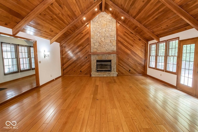 5530 Shawnee Trail S Drive, Indianapolis, IN 46220 - unfurnished living room featuring light wood-style flooring, a stone fireplace, wooden ceiling, and wooden walls