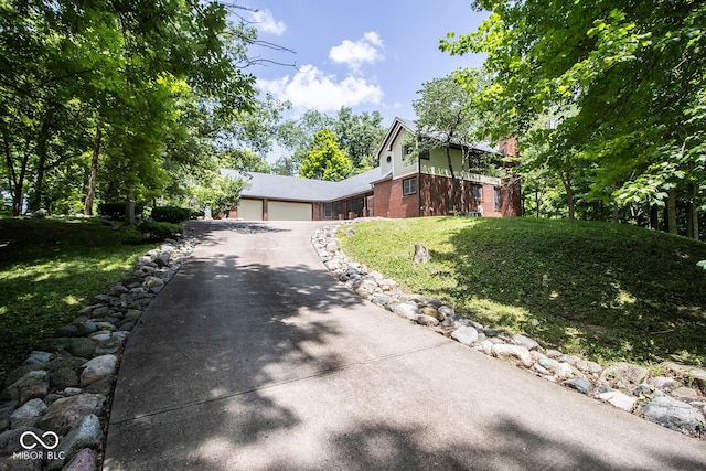 5530 Shawnee Trail S Drive, Indianapolis, IN 46220 - view of front facade with asphalt driveway, brick siding, a garage, and a front yard