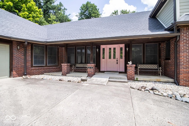 5530 Shawnee Trail S Drive, Indianapolis, IN 46220 - property entrance featuring covered porch, brick siding, and a shingled roof