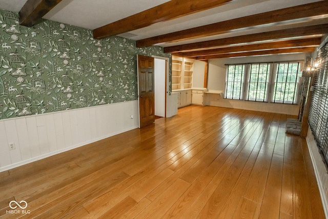 5530 Shawnee Trail S Drive, Indianapolis, IN 46220 - spare room with wallpapered walls, a wainscoted wall, beamed ceiling, and light wood-style floors
