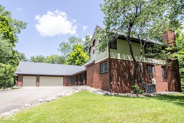 5530 Shawnee Trail S Drive, Indianapolis, IN 46220 - view of front of home featuring brick siding, concrete driveway, a front lawn, and a garage