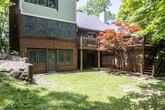 5530 Shawnee Trail S Drive, Indianapolis, IN 46220 - rear view of property with brick siding, a yard, and a deck