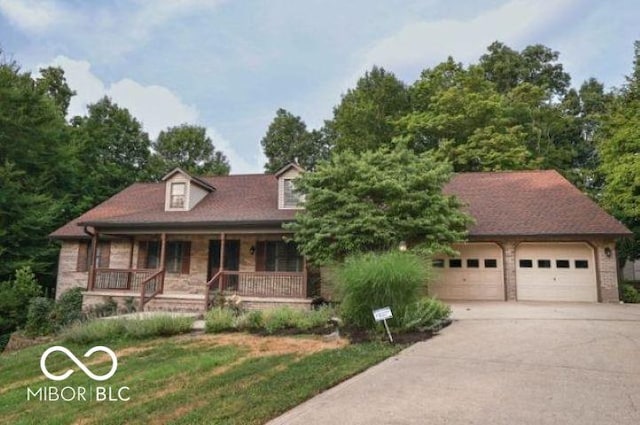 5109 N Weathers Ct, Bloomington, IN 47404 - view of front of property featuring covered porch, concrete driveway, stone siding, and an attached garage