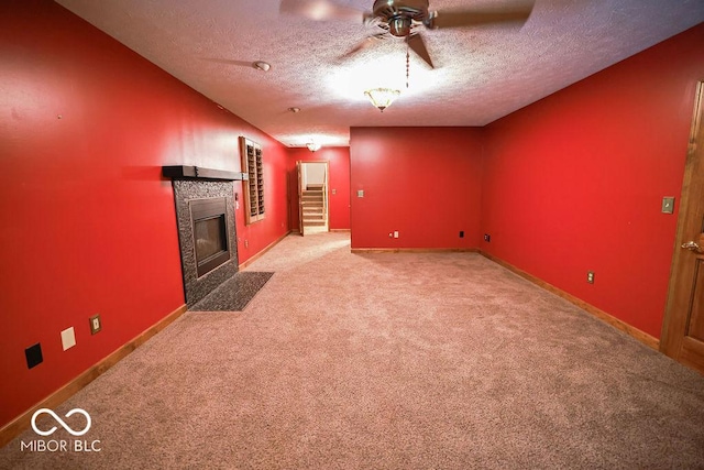 5109 N Weathers Ct, Bloomington, IN 47404 - unfurnished living room featuring a tiled fireplace, a textured ceiling, light carpet, and ceiling fan