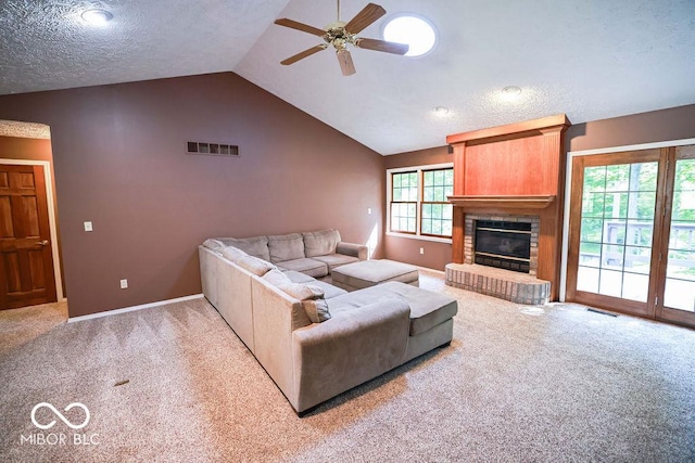 5109 N Weathers Ct, Bloomington, IN 47404 - living room featuring carpet flooring, a ceiling fan, vaulted ceiling, a fireplace, and a textured ceiling