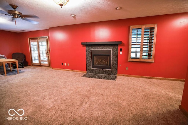 5109 N Weathers Ct, Bloomington, IN 47404 - unfurnished living room with carpet flooring, a ceiling fan, a fireplace with flush hearth, and a textured ceiling