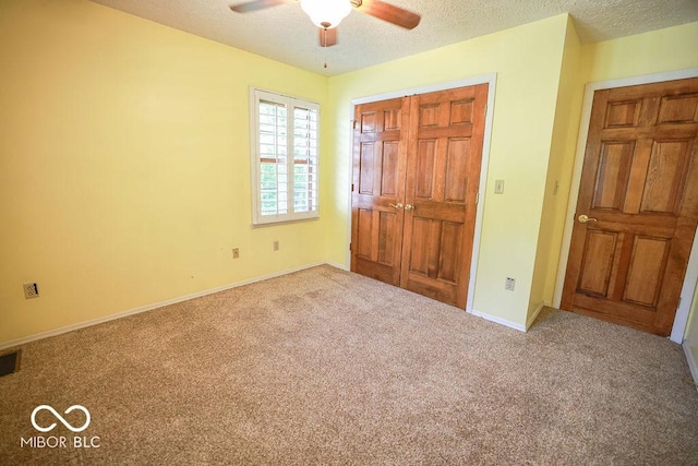 5109 N Weathers Ct, Bloomington, IN 47404 - unfurnished bedroom with carpet, a textured ceiling, and a ceiling fan