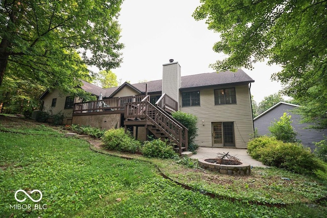 5109 N Weathers Ct, Bloomington, IN 47404 - rear view of house featuring a fire pit, stairway, a deck, a yard, and a chimney