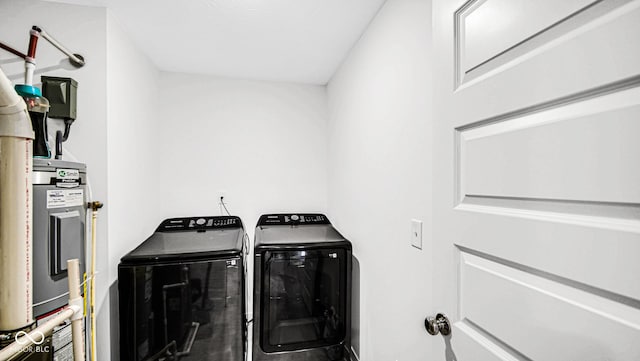 8690 Lester Pl, Pendleton, IN 46064 - laundry room with washer and clothes dryer and water heater