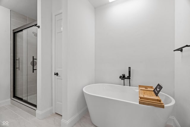 9205 Selkirk Ct, Indianapolis, IN 46260 - bathroom with a stall shower, a soaking tub, and marble look tile flooring