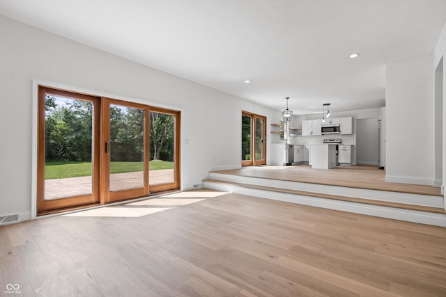 9205 Selkirk Ct, Indianapolis, IN 46260 - unfurnished living room featuring healthy amount of natural light, light wood-style flooring, and recessed lighting