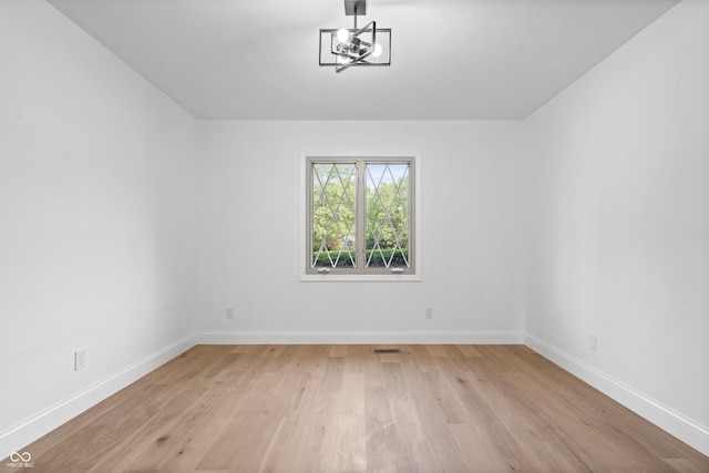 9205 Selkirk Ct, Indianapolis, IN 46260 - unfurnished room with light wood-style flooring and a chandelier
