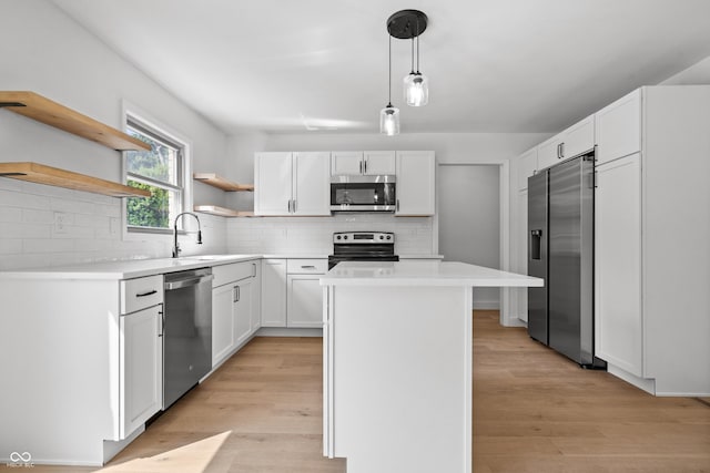 9205 Selkirk Ct, Indianapolis, IN 46260 - kitchen featuring stainless steel appliances, open shelves, a center island, white cabinets, and light countertops