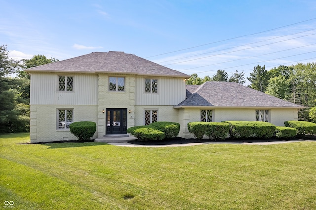 9205 Selkirk Ct, Indianapolis, IN 46260 - view of front of house featuring brick siding, a front yard, and a shingled roof