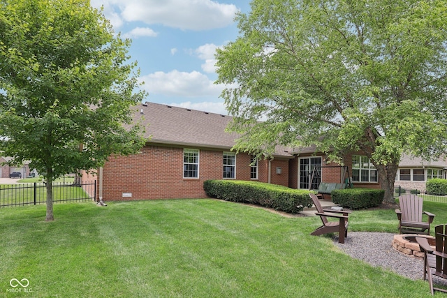 3571 S Cedar Creek Ln, New Palestine, IN 46163 - rear view of house with brick siding, a shingled roof, and an outdoor fire pit