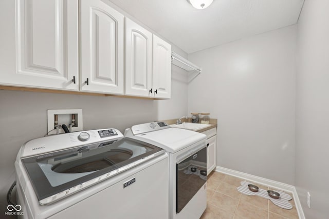3571 S Cedar Creek Ln, New Palestine, IN 46163 - laundry room featuring washer and clothes dryer, cabinet space, and light tile patterned floors