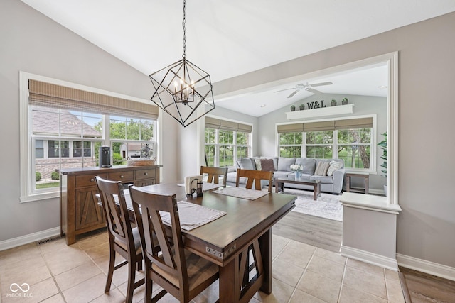 3571 S Cedar Creek Ln, New Palestine, IN 46163 - dining room featuring vaulted ceiling, light tile patterned flooring, a ceiling fan, and a chandelier