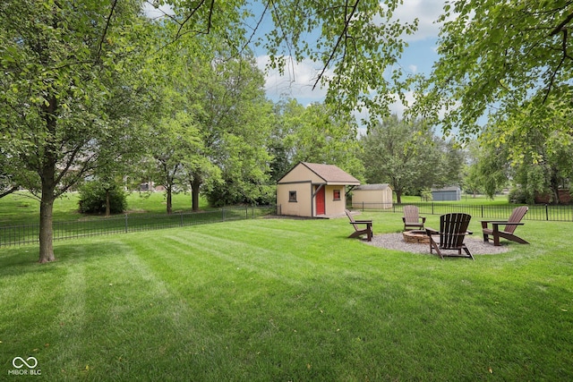 3571 S Cedar Creek Ln, New Palestine, IN 46163 - fenced backyard with a shed, a fire pit, and view of wooded area