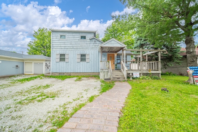 450 Columbia Ave, Tipton, IN 46072 - view of front facade featuring a deck, a front yard, and board and batten siding