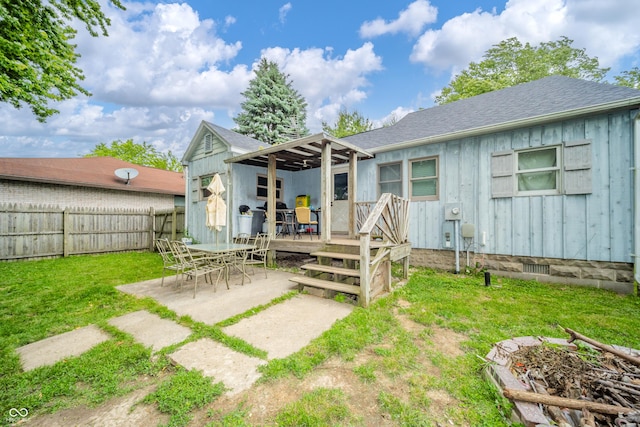450 Columbia Ave, Tipton, IN 46072 - rear view of house with a deck, a patio area, board and batten siding, and a shingled roof