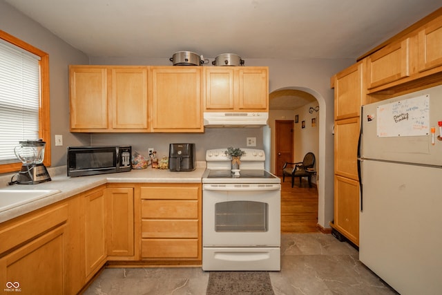 450 Columbia Ave, Tipton, IN 46072 - kitchen with white appliances, under cabinet range hood, and light brown cabinetry