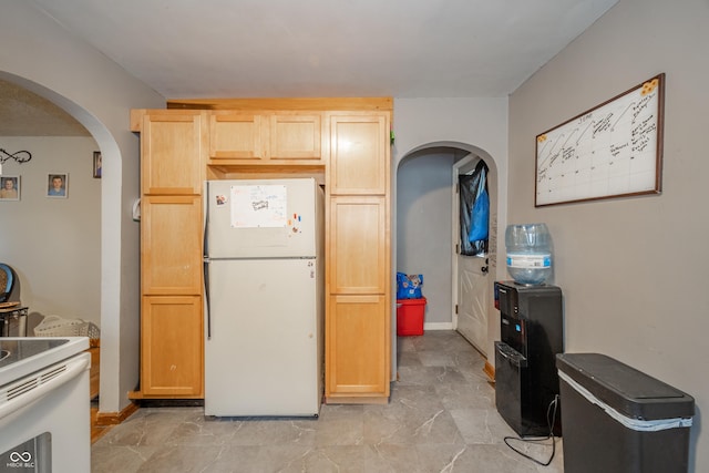450 Columbia Ave, Tipton, IN 46072 - kitchen featuring white appliances, arched walkways, and light brown cabinets