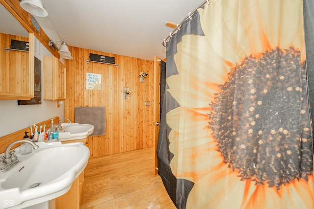 450 Columbia Ave, Tipton, IN 46072 - full bath featuring a sink, wooden walls, wood finished floors, and a shower with curtain