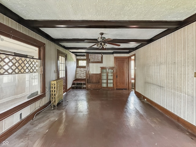4715 E New York St, Indianapolis, IN 46201 - unfurnished room with baseboards, a textured ceiling, wood finished floors, ceiling fan, and radiator heating unit