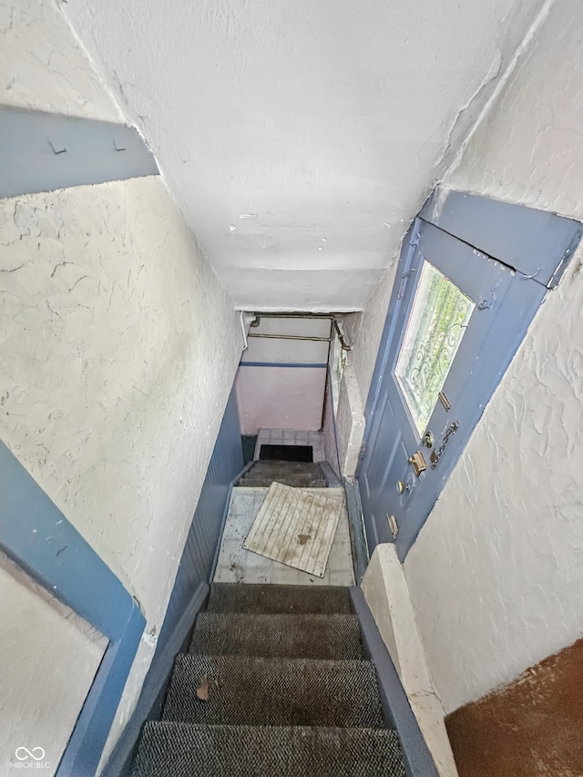 4715 E New York St, Indianapolis, IN 46201 - staircase with a textured wall