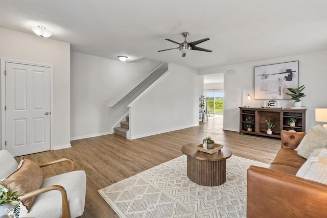 10112 Gallop Ln, Fishers, IN 46040 - living area featuring wood finished floors, ceiling fan, and stairs