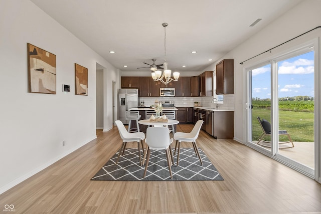 10112 Gallop Ln, Fishers, IN 46040 - dining area with a chandelier, light wood finished floors, and recessed lighting