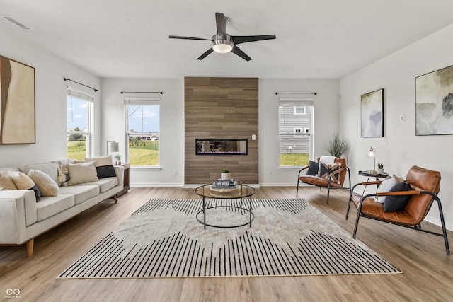10112 Gallop Ln, Fishers, IN 46040 - living area with wood finished floors, a large fireplace, and ceiling fan