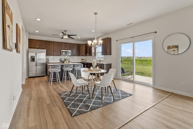 10112 Gallop Ln, Fishers, IN 46040 - dining space featuring a chandelier, light wood-style flooring, recessed lighting, and a ceiling fan