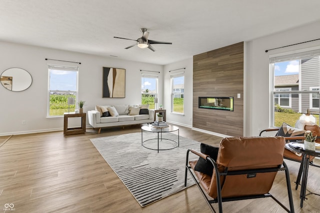 10112 Gallop Ln, Fishers, IN 46040 - living area with a fireplace, healthy amount of natural light, a ceiling fan, and wood finished floors