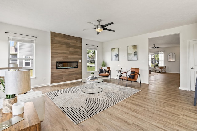 10112 Gallop Ln, Fishers, IN 46040 - living area with a ceiling fan, a fireplace, and wood finished floors