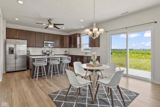 10112 Gallop Ln, Fishers, IN 46040 - dining area featuring a chandelier, light wood-style floors, recessed lighting, and a ceiling fan