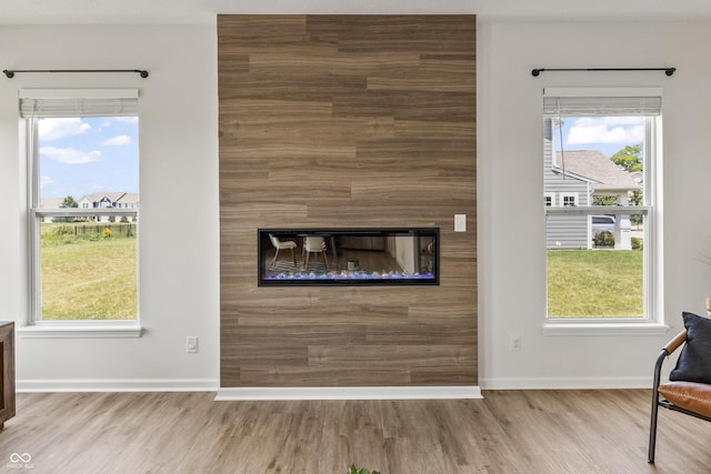 10112 Gallop Ln, Fishers, IN 46040 - unfurnished living room featuring wood finished floors, a fireplace, and plenty of natural light