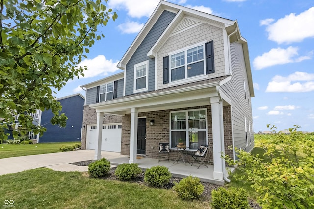 10112 Gallop Ln, Fishers, IN 46040 - view of front of house featuring a porch, concrete driveway, brick siding, a garage, and a front yard