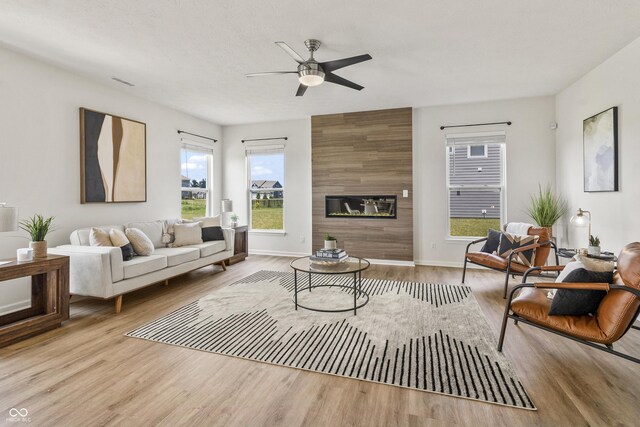 10112 Gallop Ln, Fishers, IN 46040 - living room with a ceiling fan, wood finished floors, and a large fireplace