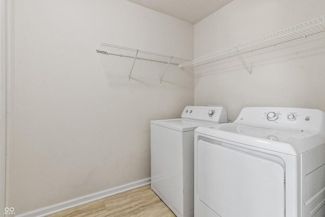 10112 Gallop Ln, Fishers, IN 46040 - laundry room featuring washer and dryer and light wood-type flooring