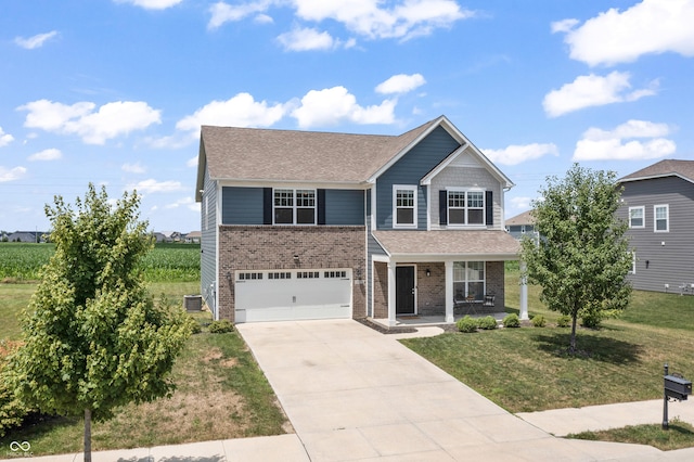 10112 Gallop Ln, Fishers, IN 46040 - view of front of house featuring a porch, brick siding, driveway, a garage, and a front yard