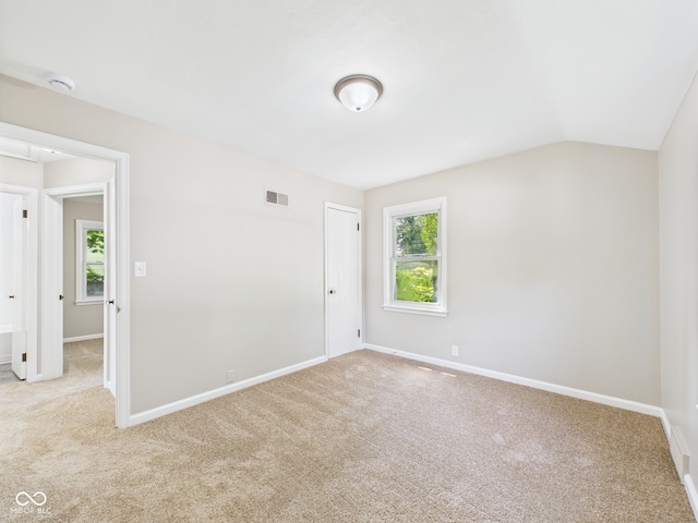 220 Central Ave, Anderson, IN 46012 - unfurnished bedroom with carpet, baseboards, and lofted ceiling