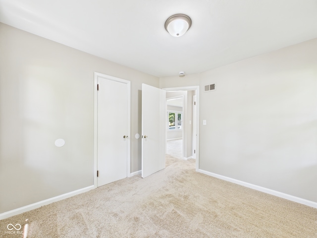 220 Central Ave, Anderson, IN 46012 - spare room featuring carpet flooring, baseboards, and a smoke detector