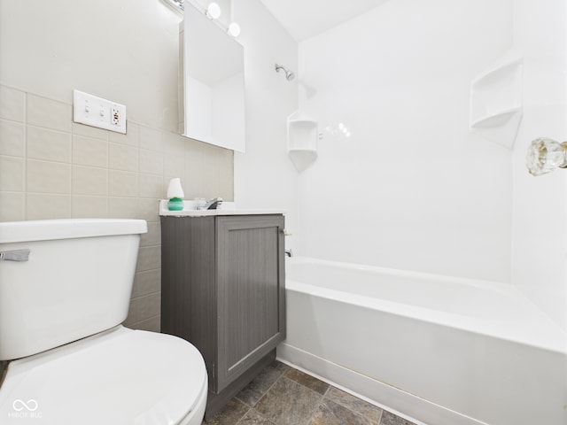 220 Central Ave, Anderson, IN 46012 - full bathroom featuring toilet, tile walls, bathing tub / shower combination, and vanity