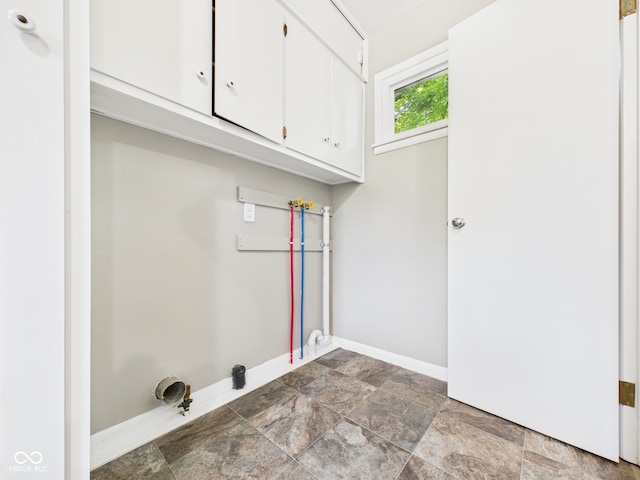 220 Central Ave, Anderson, IN 46012 - washroom with cabinet space, baseboards, and stone finish flooring
