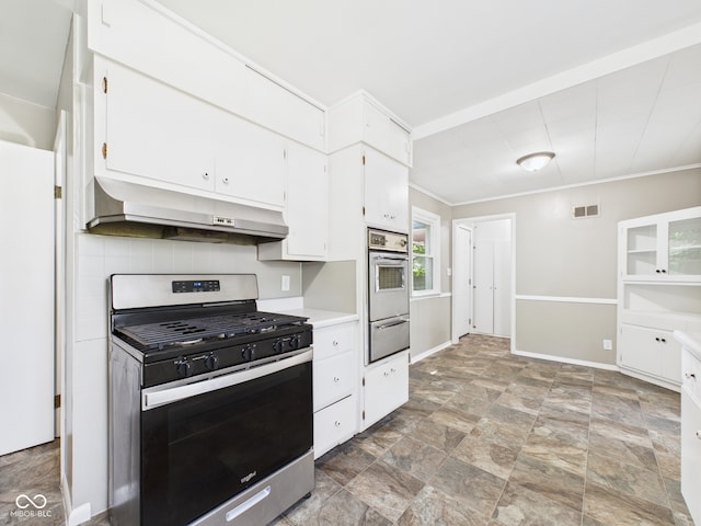 220 Central Ave, Anderson, IN 46012 - kitchen featuring stainless steel range with gas cooktop, under cabinet range hood, wall oven, a warming drawer, and white cabinetry